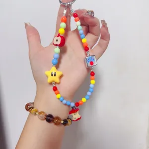 Detailed view of colorful dopamine beaded phone charm with cute star and mushroom pendants.