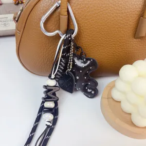 Korean style chic black bear bag charm pendant with braided strap and pearl beads for bags.