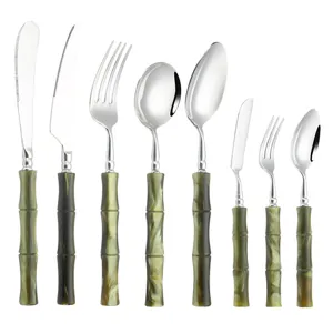 Stainless steel cutlery set with acrylic green handles, elegant steak knives, forks and spoons.