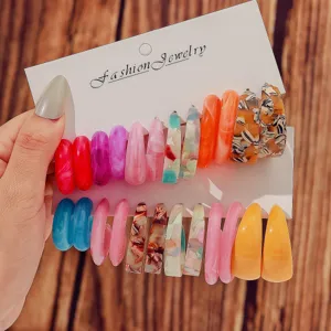 Colorful resin C-shaped hoop earrings set, trendy fashion jewelry display on cards, detail view.
