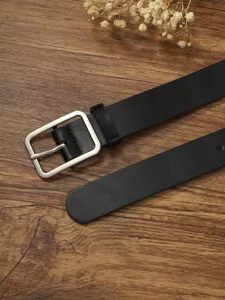 Close-up detail view of the black leather belt featuring a chic silver square metal buckle.