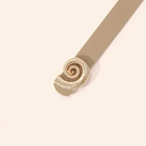 Detailed view of the women's stylish skinny belt with a unique gold shell buckle.