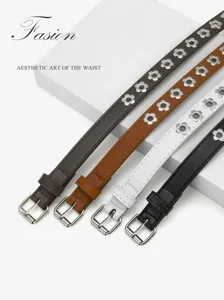 Detail view of punk style flower punched grommet PU thin belt, versatile jeans accessory.