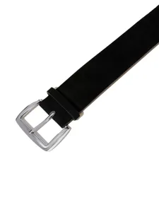 Close-up detail of the black suede belt with a polished silver metal buckle, fine texture.