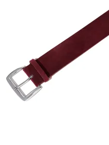Close up view of the dark red suede wide belt featuring a polished silver metal buckle.