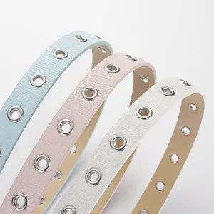 Slim candy color leather belt for women and kids, stylish decorative accessory with metal eyelets.