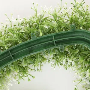 Close-up detail of artificial flower garland green backing frame and foliage for decor.