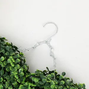 Close-up view of the metal hanging hook and chain for artificial green plant garland decor.