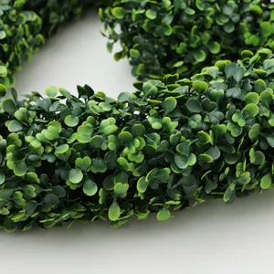 Closeup detail of artificial green boxwood heart wreath foliage texture photography prop