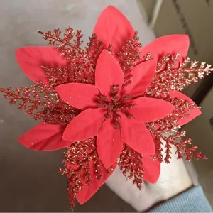 Red artificial Christmas poinsettia flower with glitter petals for holiday tree home decor.