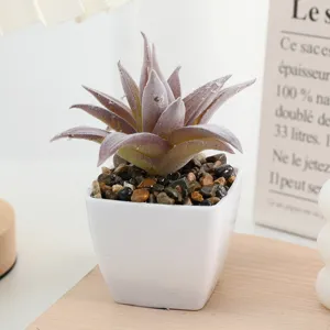Close-up detail of artificial flocking succulent plant in mini white square pot for home decor.