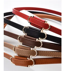 Closeup of women's thin PU leather belts in multiple colors with elegant gold-tone metal buckles.