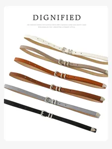 Detailed view of women's thin leather belt with silver metal buckle, minimalist style.