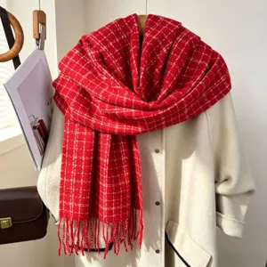 Red plaid scarf texture detail, winter warm tassel shawl closeup display on white coat