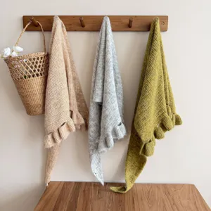 Knitted ruffle shawl detail view, cozy winter cape and versatile warm scarf in multi colors.