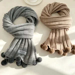 Cozy knit winter scarf for women, thick warm wool neck warmer with cute pom poms style.
