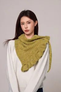 Cozy ruffle knitted shawl for women, loose autumn winter cape and stylish knitwear detail.
