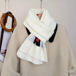 Cozy white knitted winter scarf with a stylish black and red contrast detail, soft and warm neck warmer.
