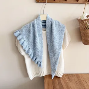 Light blue knitted ruffled shawl with soft wool texture, perfect elegant layering accessory.