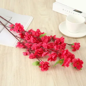 Red artificial peach blossom branch, fake plum flowers for home decoration and party display.