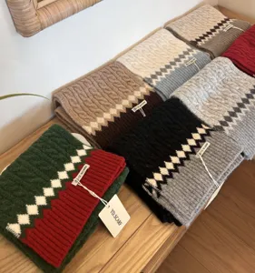 Cozy winter knit scarf for women, classic cable knit design, warm and soft fashion accessory.