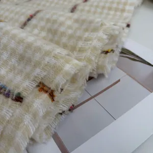 Close-up of thick warm houndstooth plaid scarf fabric texture detail winter accessory.