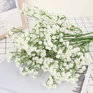 Detailed shot of artificial baby's breath flower bouquet with green stems and white blossoms for decor.