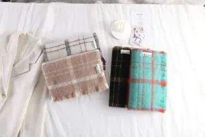 Detail shot of cozy mohair plaid scarf in multiple colors, winter warm neck wrap.