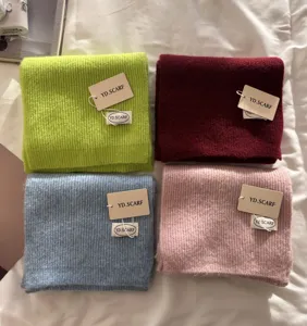 Close up view of soft knitted winter scarves in various colors detailed presentation display