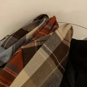 Close-up of classic plaid pattern imitation cashmere scarf detail, soft and warm winter accessory.