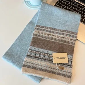 Detail view of the Nordic style knitted wool scarf featuring blue and brown geometric patterns.