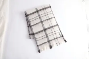 Detail view of the soft mohair plaid winter scarf, showing cozy texture and classic pattern.