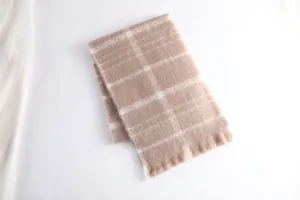 Detail view of the thick warm mohair plaid winter scarf texture and soft fringe edges.