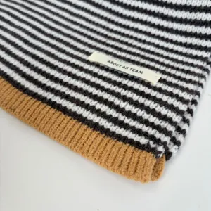 Close-up detail of a retro color-blocked striped knitted wool scarf for autumn and winter.