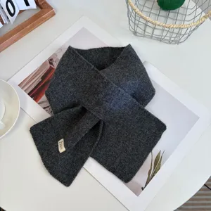 Cozy dark grey knitted cross scarf for women, trendy winter warm wool neck warmer.