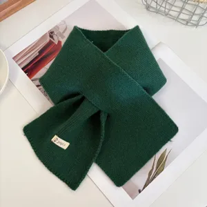 Dark green knit cross scarf detail, cozy winter woolen neck warmer, soft and stylish daily wear.