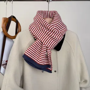 Red and white striped knitted scarf with navy border, cozy winter neck warmer for daily wear.