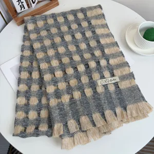 Winter warm knitted plaid scarf with hollow-out design and fringe trim in grey and beige.