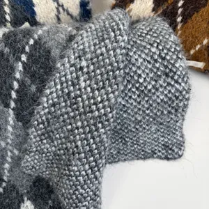 Detailed view of fluffy argyle mohair winter scarf texture, soft warm knit fabric.