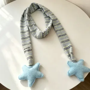 Cute knitted striped scarf with plush star ends, warm winter accessory for women daily wear.