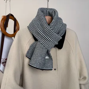 Black and white striped knit scarf detail, classic winter warm cozy accessory style.