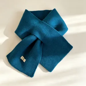 Solid color knitted criss-cross scarf for women, warm winter fashion casual accessory.