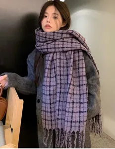Detail view of a vintage plaid winter scarf for women, thick cashmere-feel tassel design.