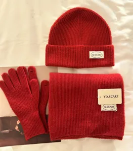 Red knit winter hat scarf and gloves set soft warm woolen knitted three-piece set detail view.