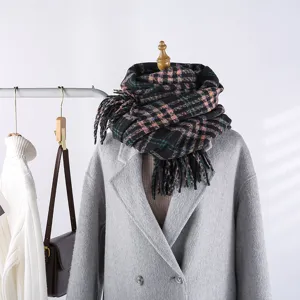 Cozy winter plaid scarf detail, colorful checkered design with soft tassel fringe for chilly days.