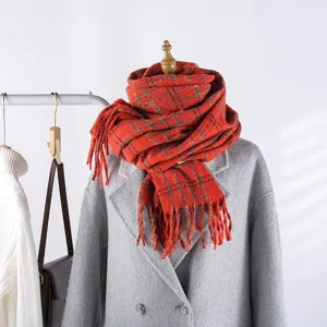 Winter colorful plaid scarf detail, cozy long fringed wrap, warm winter neckerchief accessory.