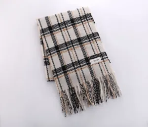 Cozy autumn winter plaid scarf detail showing soft imitation cashmere texture and elegant fringe.