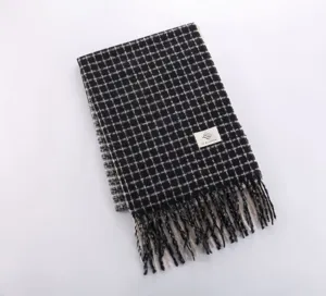 Detailed close up view of this cozy autumn winter plaid fringe cashmere feel scarf product shot.