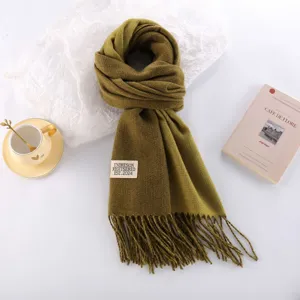 Thick imitation cashmere scarf in solid olive green with fringe detail and woven label accent.