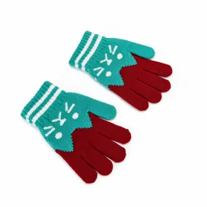 Detailed view of kids winter knitted gloves, red and green contrast with cute white stripes.